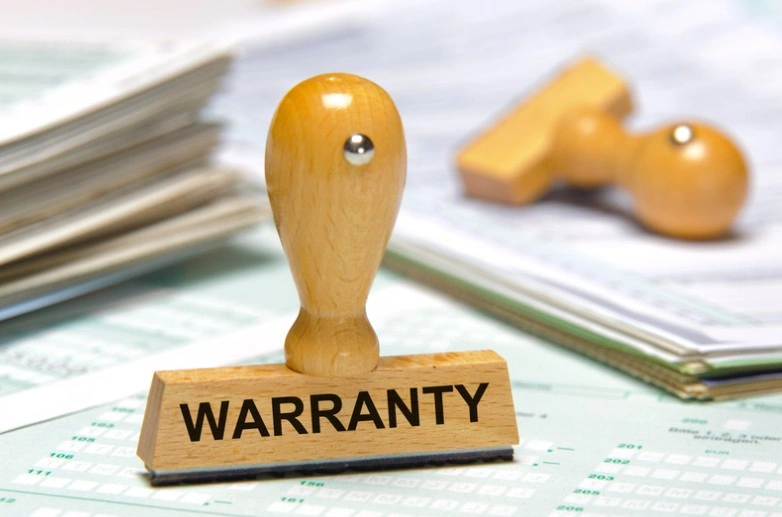 Wooden warranty stamp on a stack of documents and spreadsheets, 247lemonlaw