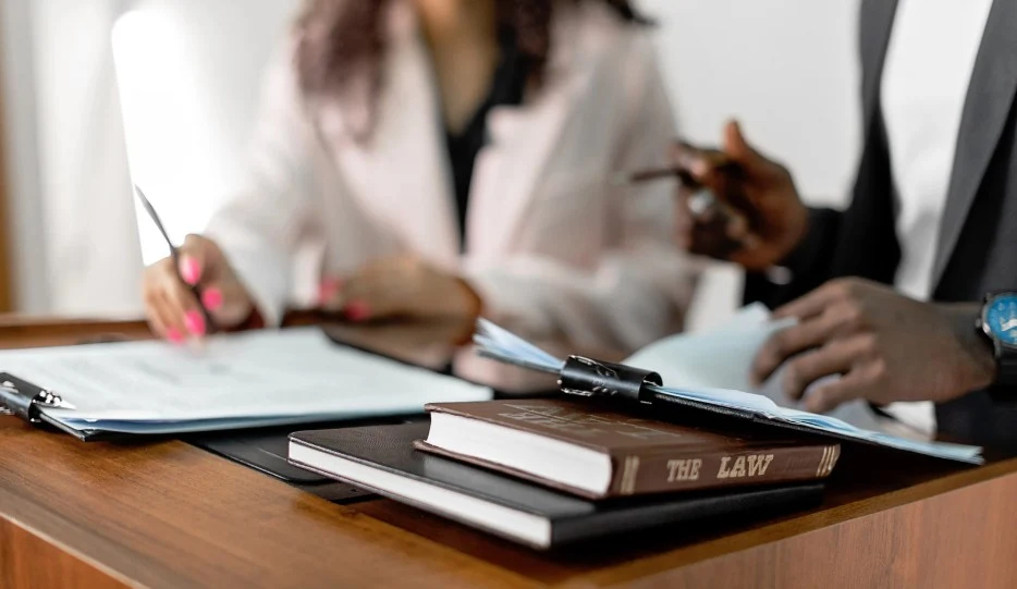 Individuals reviewing legal documents, suggesting a Lemon Law consultation, 247lemonlaw