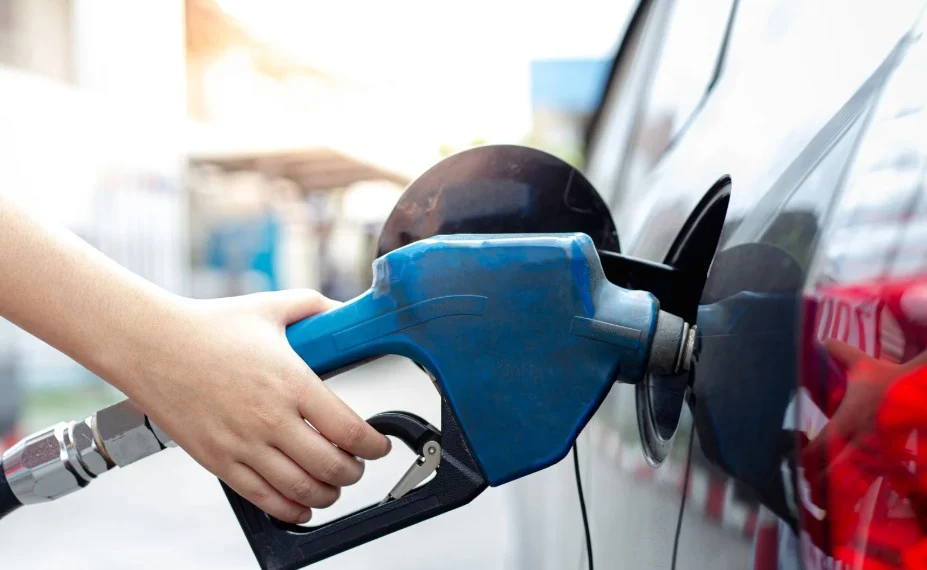 Vehicle owner refueling car experiencing Chevy 2.7 turbo problems and engine issues
