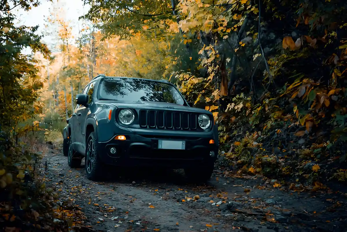 Jeep Renegade driving on a forest trail highlighting Jeep Renegade years to avoid due to known reliability issues