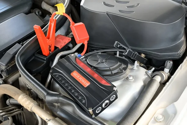 Car engine with jump starter connected for battery issue