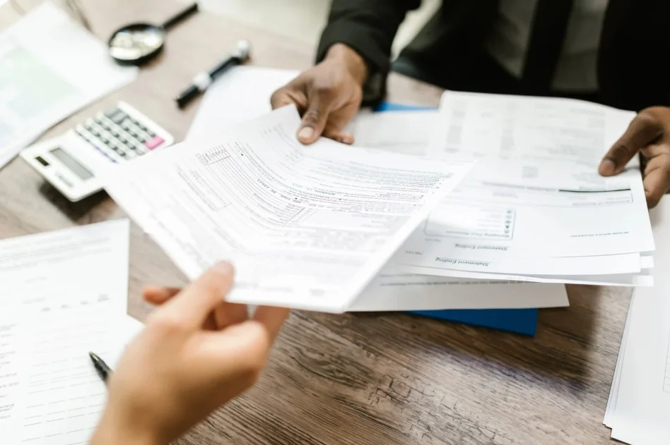 Client and legal expert analyzing auto purchase documents for Lemon Law case