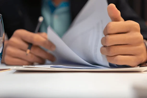 Close-up of person reviewing car purchase documents for potential lemon law claim