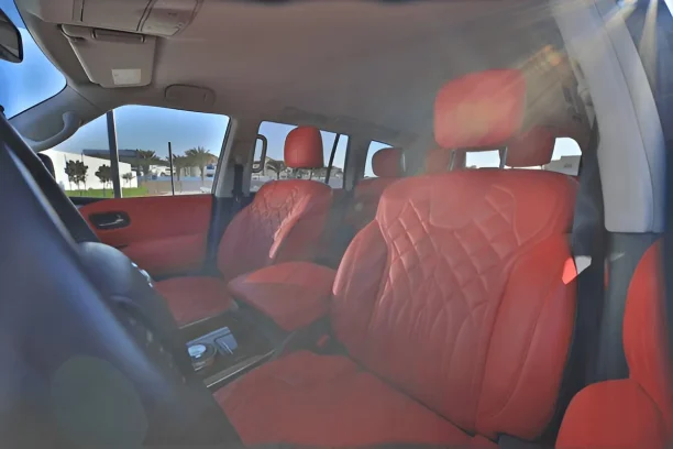 Interior of a defective vehicle with red leather seats showing issues for Lemon Law cases
