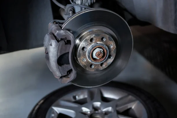 Close up of car brake rotor and wheel part highlighting defective vehicle concerns