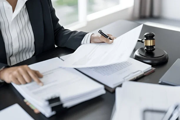 Lemon law attorney reviewing legal documents to help car owners with defective vehicles, 247lemonlaw
