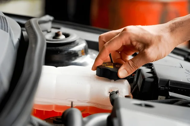 Mechanic checking coolant reservoir under car hood for lemon law inspection