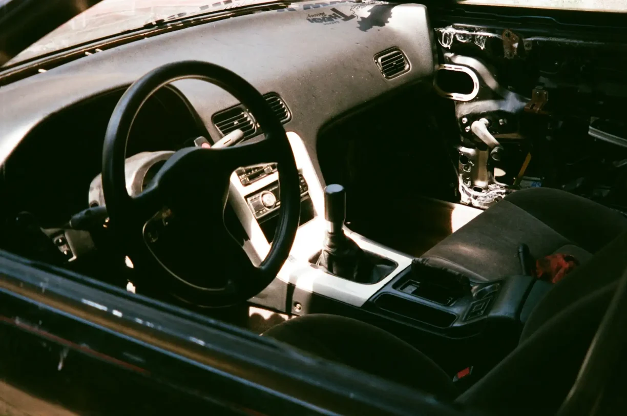 Vehicle interior showing dashboard and steering wheel with malfunctioning electronics as one of the symptoms of a bad PCM