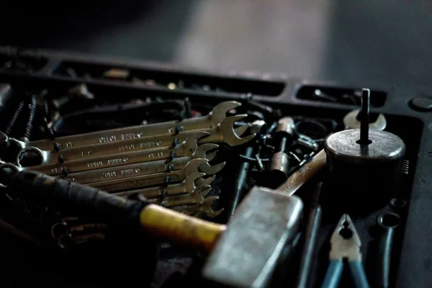 A set of automotive repair tools and wrenches used for diagnosing vehicle defects.