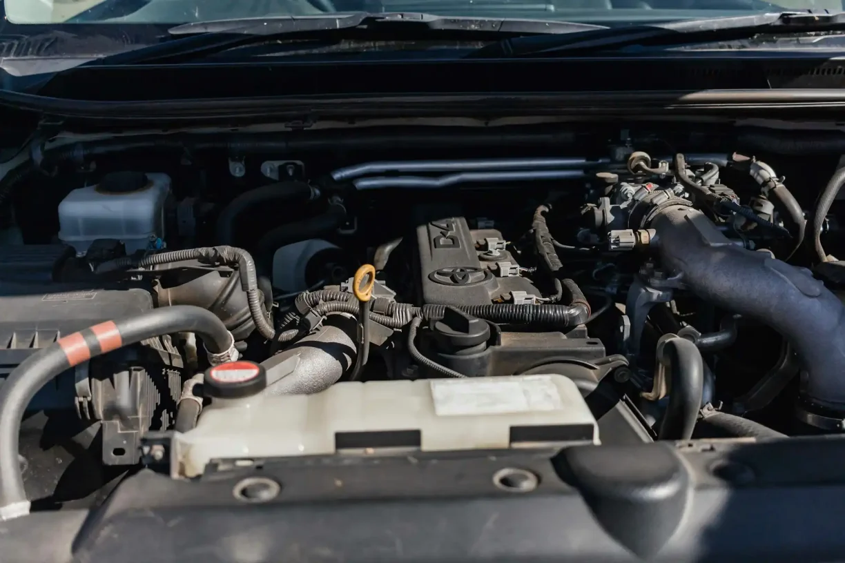 Car engine components being inspected for recurring mechanical issues under lemon law protection