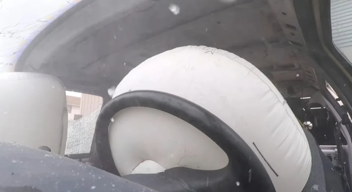 Deployed driver airbag inside vehicle after collision
