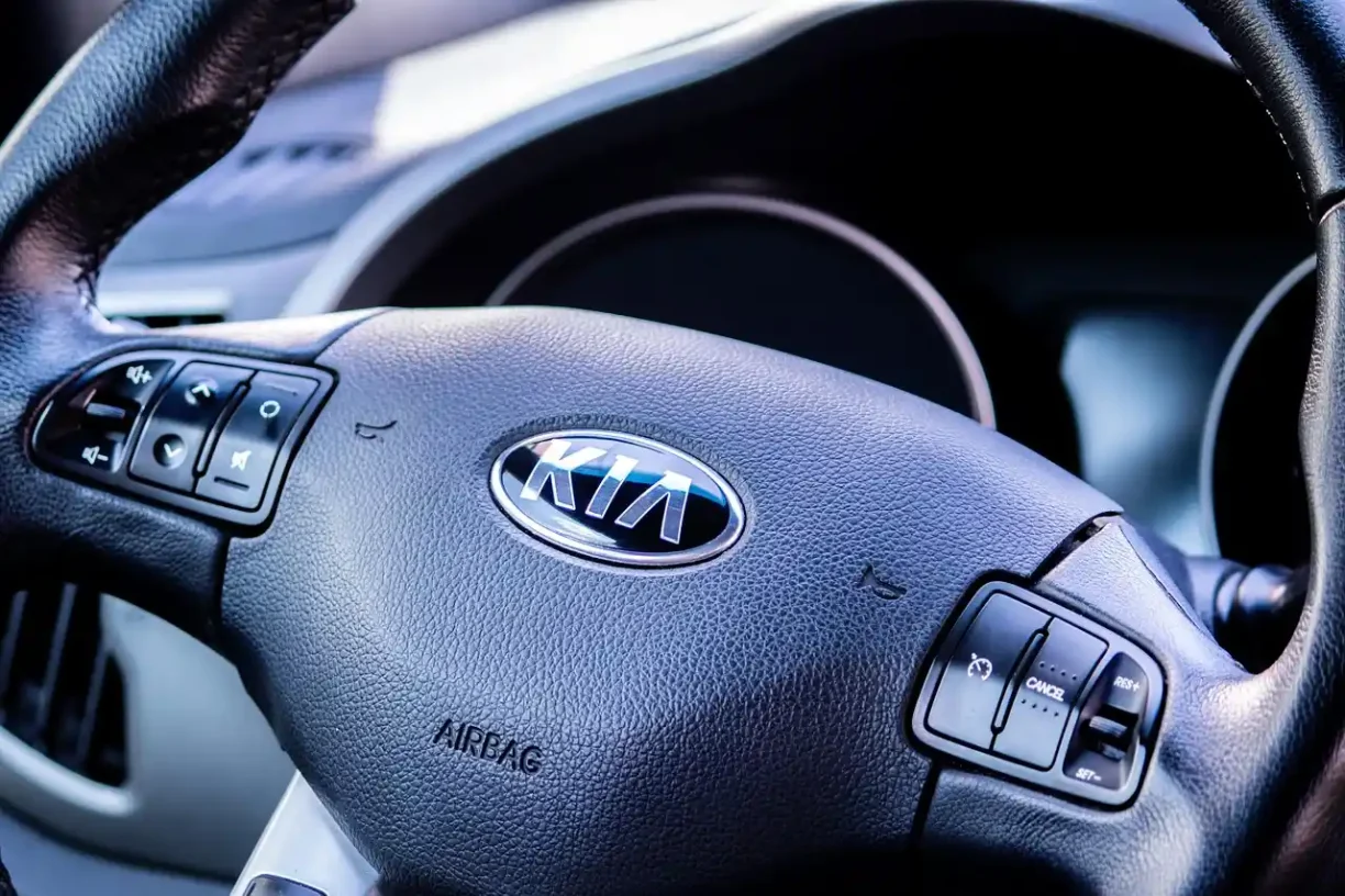 Interior view of a Kia vehicle showing the steering wheel and airbag controls