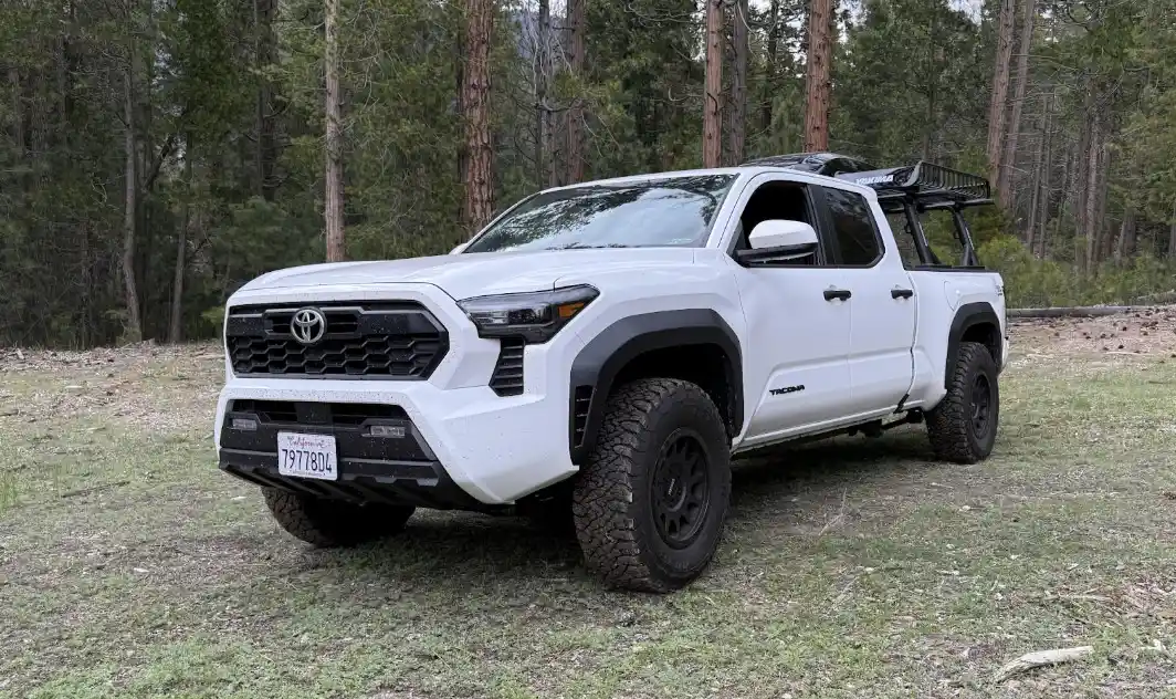 White 2025 Toyota Tacoma with off-road tires showing common 2025 Tacoma problems that may qualify for lemon law